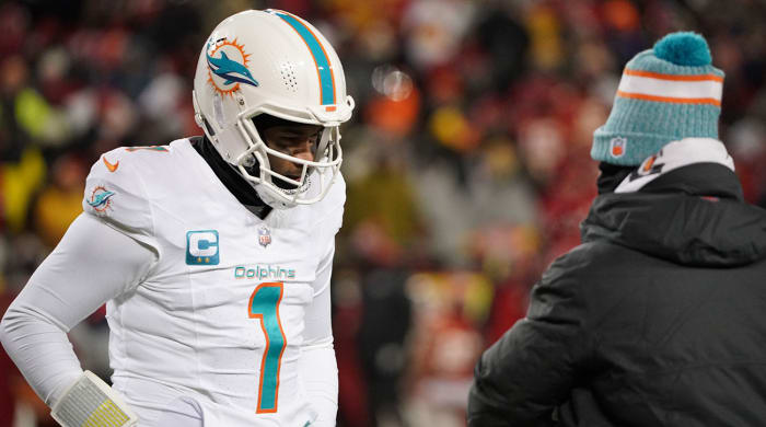 Tua Tagovailoa talks to Mike McDaniel on the sideline during a wild-card loss to the Chiefs in frigid temperatures.